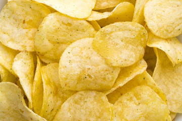 Close up potato chips on top view background.