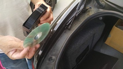 Man sharing a CD from his trunk audio player