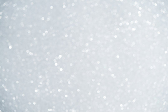 Unfocused abstract white glitter bokeh holiday background. Winter xmas holidays. Christmas.