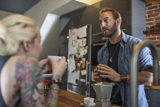 Barista talking with customer in cafe