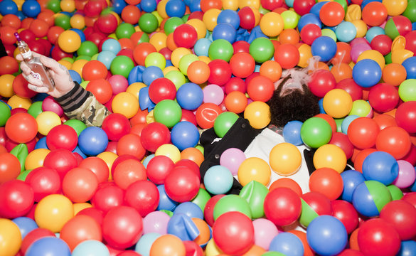 Young man playing in a ball pit