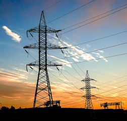 silhouette of power lines in the factory and sunset background