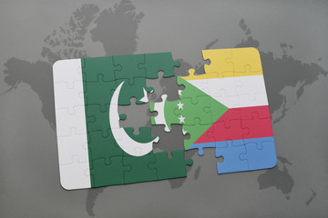 puzzle with the national flag of pakistan and comoros on a world map background.