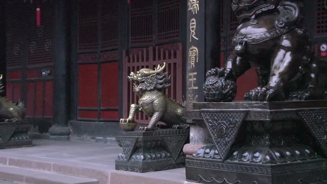 Zoom out from dragon statue next to a temple inside the Wenshu Monastery