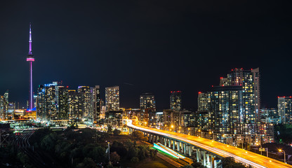 Glowing light streaks from traffic along the Gardiner Expressway on a hot & muggy summer night in Lakeside Toronto, Canada.