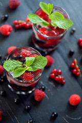 fruit coctaile and color berries on natural dark wooden desk