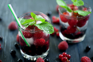 fruit coctaile and color berries on natural dark wooden desk