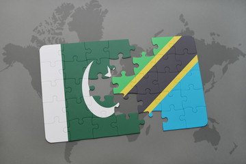 puzzle with the national flag of pakistan and tanzania on a world map background.