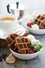 Chocolate waffles with meringues and coffee