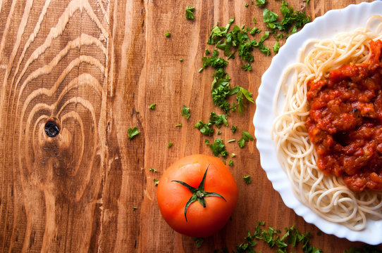 Italian spaghetti on a wooden table with text space