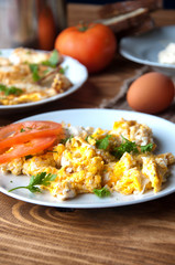 Scrambled, fried, boiled eggs on a wooden table