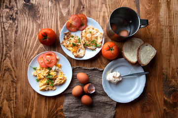 Obraz na płótnie Canvas Scrambled, fried, boiled eggs on a wooden table