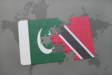 puzzle with the national flag of pakistan and trinidad and tobago on a world map background.