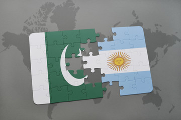 puzzle with the national flag of pakistan and argentina on a world map background.
