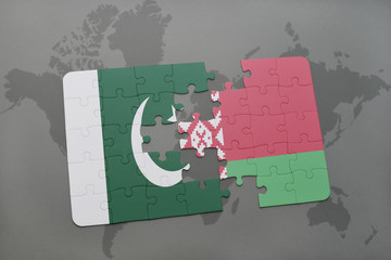 puzzle with the national flag of pakistan and belarus on a world map background.