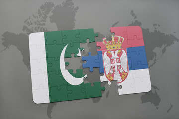 puzzle with the national flag of pakistan and serbia on a world map background.