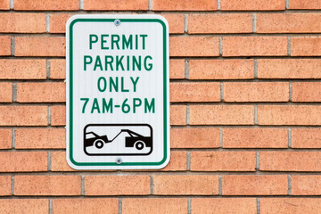 Permit Parking only 7 am to 6 pm sign on a brick wall