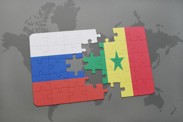 puzzle with the national flag of russia and senegal on a world map background.