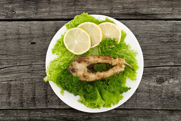 Roasted fish with fresh herbs and lemon 