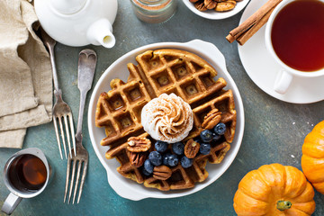 Pumpkin waffles with whipped cream for breakfast