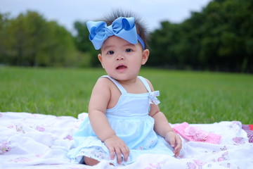 Portrait of a beautiful baby girl,Cute baby 7 months, close-up portrait,Beautiful baby girl in park,Little asian girl was playing happily and smiling in the park