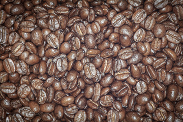 Coffee beans closeup. Roasted brown coffee beans texture or coffee beans background for design.