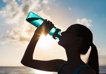 Female drinking bottle of water. 