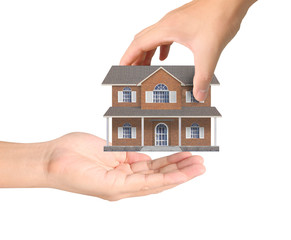 Mortgage concept by house from hand