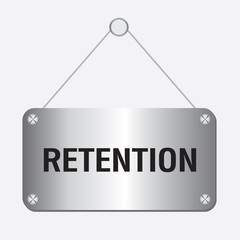 silver retention sign hanging on the wall 