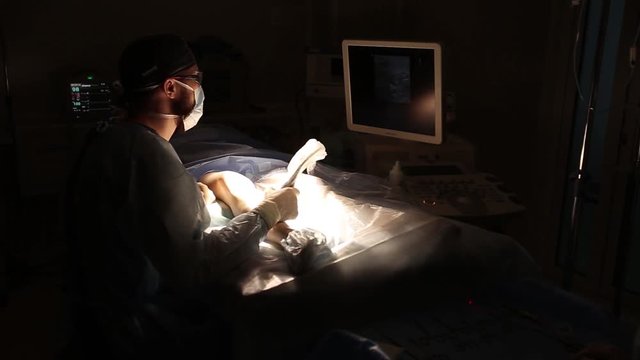 Doctor looking at modern ultrasound device