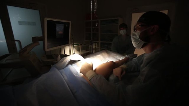 Doctor looking at modern ultrasound device