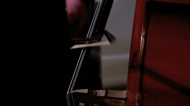 View of cellist's hands with fiddlestick