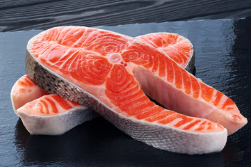 Fresh salmon on a dark background.