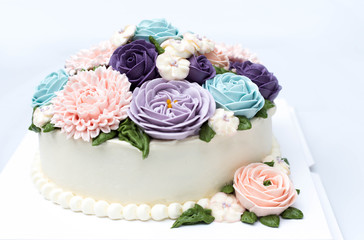 Birthday cake with colorful flowers isolated