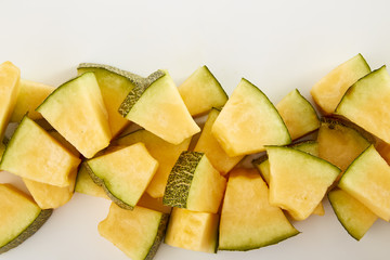 Hamigua Melon cut into slices, Hami Melon, Hami Cantaloupe isolated on white background.