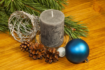 New Year 2017 composition with fir cones and candle on wooden ba