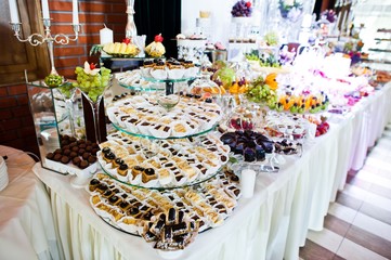 Elegance wedding reception table with food and decor.