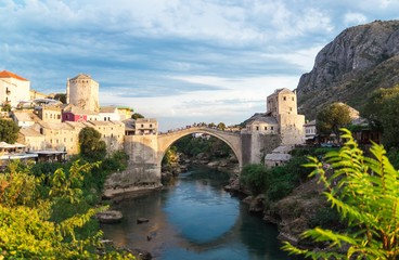 Fototapeta na wymiar Beautiful landscape of the historic town of Mostar in the lights of the sunset, valley of the Neretva River