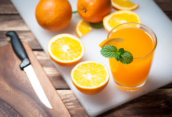 Fresh fruits Orange juice in glass on wood