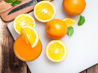 Fresh fruits Orange juice in glass on wood