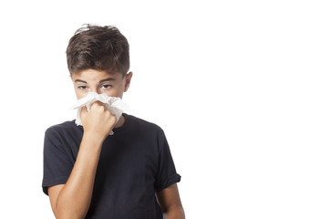 child blowing the nose has a cold
