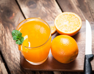 Fresh fruits Orange juice in glass on wood,Selective focus on gl
