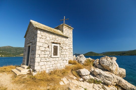 little old chapel on the island, sea in the background
