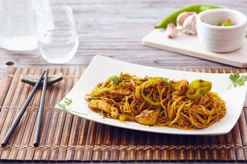 sweet chili noodles in a white serving plate with chopsticks, bright colors, modern style