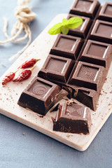 Dark chocolate on a white chopping board, light and bright colors