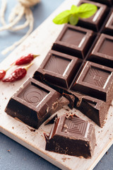 Dark chocolate on a white chopping board, light and bright colors