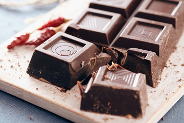 Dark chocolate on a white chopping board, light and bright colors