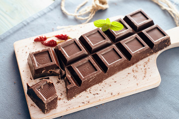 Dark chocolate on a white chopping board, light and bright colors