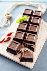 Dark chocolate on a white chopping board, light and bright colors