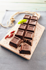 Dark chocolate on a white chopping board, light and bright colors